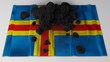 Coal on top of the flag of Åland (3D render)