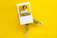 Full Length Photo Of Attractive Funky Cheerful Lady Dancing Holding Frame Have Fun Enjoy Isolated On Bright Yellow Color Background