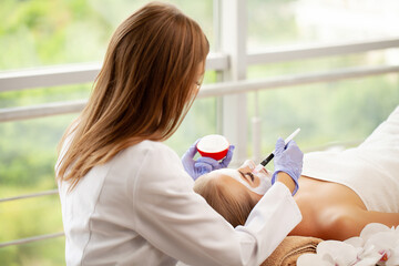 Sticker - Beautiful woman with facial mask at beauty salon