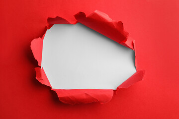 Sticker - Hole in red paper on white background