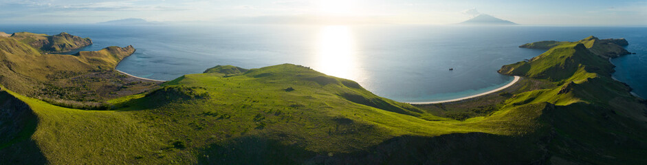 Afternoon sunlight illuminates the beautiful coastline of Pulau Banta near Komodo in Indonesia. This area, part of the Coral Triangle, is known for its extraordinary marine biodiversity.