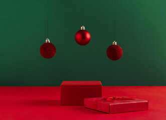 Wall Mural - Creative Christmas concept made of podium and red baubles on bold green background. Minimal New Year advertisement concept. Mock up showcase for product, promotion, sale or presentation.