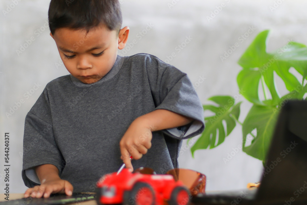 Boy Learning Tech Asian boy students learn at home in coding robot cars and electronic ...