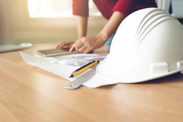 female engineer drawing equipment on the table