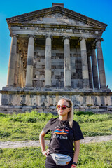 A young girl near the temple of Garni pagan, a Greek temple in the Republic of Armenia. May 3, 2019.