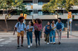 Urban students on crosswalk.