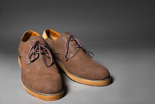 Pair Of Men's Brown Suede Shoes On Grey Background.