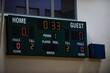 Digital indoor main scoreboard for a volleyball tournament in a gymnasium. Seeing a game about to start soon.