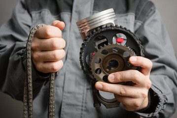 Wall Mural - A car mechanic is showing an old car spare parts close up background.