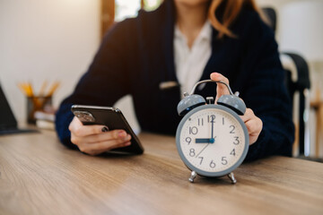 Wall Mural - alarm clock on the desk. business working in modern office building or home at night using laptop..