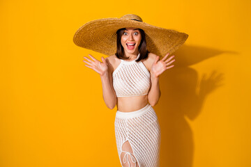 Wall Mural - Photo of excited funky girl dressed knitted bra straw cap rising arms empty space isolated yellow color background