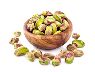 Wall Mural - Shelled Pistachios in closeup isolated. Nuts  in wooden bowl on white background