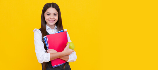 Poster - Happy schoolchild in uniform hold apple and books yellow background, back to school. Banner of schoolgirl student. School child pupil portrait with copy space.