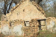 The Ruins Of An Old House On A Bright Sunny Day. The Ruins Of A Structure Made Of Stone.