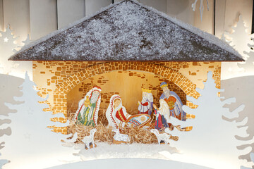 Nativity scene. Holy night scene with saint figurines and baby Jesus in creche.Christmas decor in city street. Winter holidays in Europe. Merry Christmas