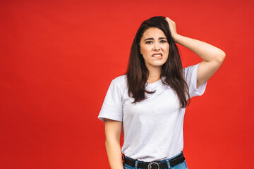 Canvas Print - OMG! Portrait of amazed shocked surprised young woman isolated over red background.