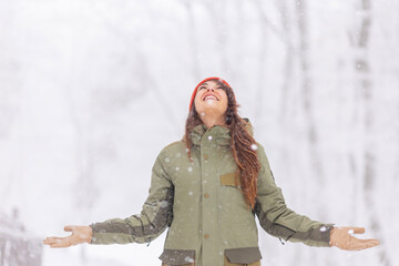 Wall Mural - Woman enjoying snowy winter day outdoors