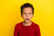 Photo portrait of charming little pupil boy look confused open mouth wear trendy red knitwear garment isolated on yellow color background