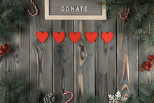 Donation Abstract Composition With Red Heart Garland On Dark Wooden Christmas Decorative Background. Charity, Donation