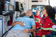 © zinkevych - Female paramedic monitoring the patient heart rate using medical equipment