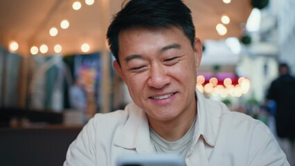 happy satisfied man holding mobile phone reading good news responding to email sends message using a