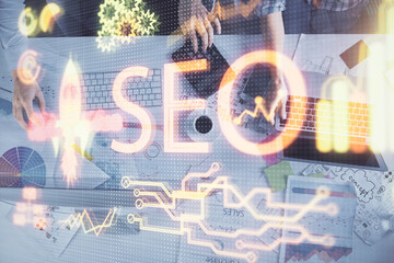 Poster - Double exposure of man and woman working together and seo drawing hologram. Technology concept. Computer background.