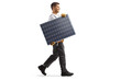 © Ljupco Smokovski - Full length profile shot of a technician carrying a solar panel and walking