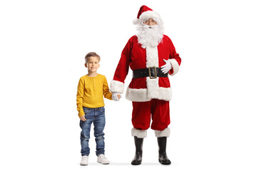 Canvas Print - =Full length portrait of santa claus holding hands with a boy