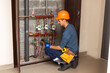 © Angelov - Technician inspecting heating system in boiler room