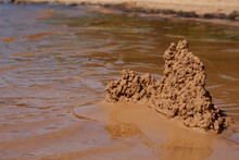 Sand Castle On The Beach Near The Water