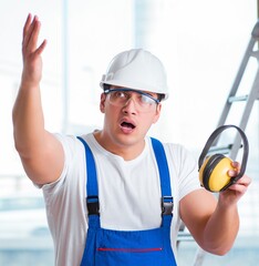 Wall Mural - Young worker with noise cancelling headphones