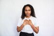 Portrait of frightened young woman breathing sigh of relief. Amazed African American lady wearing white T-shirt posing with open mouth touching chest. Fear and astonishment concept