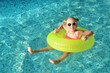 © New Africa - Happy little girl with inflatable ring in outdoor swimming pool on sunny day