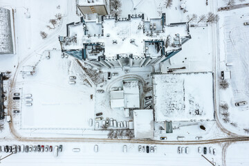 Wall Mural - snow-covered roof of high-rise office building. aerial overhead view.