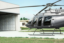 Beautiful Helicopter On Helipad In Field Near Hangar