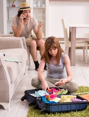 Wall Mural - Young couple preparing for trip