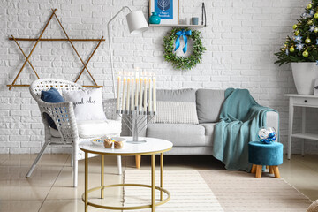 Interior of living room with sofa and table decorated for Hanukkah celebration