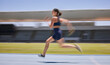 © L Ismail/peopleimages.com - Woman, motion blur or running on stadium track in fitness training, workout or exercise for race, marathon or competition challenge. Runner, sports athlete or fast movement and speed in energy cardio