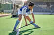 Sports, hockey and woman in action on field with hockey stick ready to hit ball in game. Fitness, exercise and female athlete playing field hockey in outdoor stadium for workout, training and health