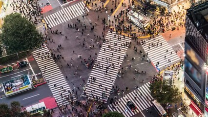 Wall Mural - Night time lapse of car traffic transportation, crowded people walk cross road at Shibuya scramble crossing. Tokyo tourist attraction landmark, Japan tourism, Asia transport or Asian city life concept