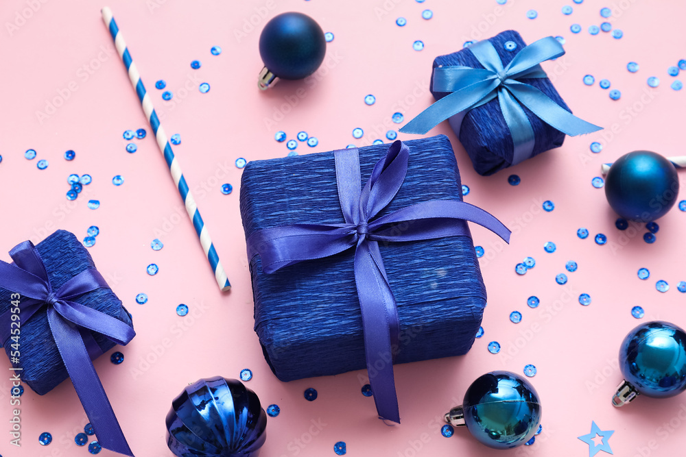 Gift boxes with Christmas decor on pink background