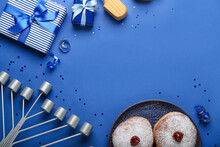 Frame Made Of Plate With Donuts, Menorah And Gifts For Hanukkah Celebration On Blue Background