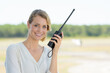 woman smiling holding walkie talkie