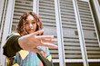 © C Daniels/peopleimages.com - Black woman, hand or fashion clothes in city center, town or urban location in New York city cool, trendy or style clothing. Portrait, model or student by buildings in funky, hipster or retro shirt