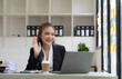 © wichayada - Beautiful Asian businesswoman is on video call with customer on laptop in office and has a negotiating gesture. smiling and happy face.