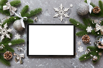 Wall Mural - Top view of empty tablet on Christmas background made of new year decorand festive decorations. New year holiday concept. Mockup