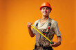 © fotofabrika - Young male builder holding measuring roulette against yellow background