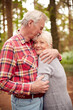 © Monkey Business - Loving Retired Senior Couple Hugging On Walk In Woodland Countryside Together