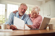 © Monkey Business - Worried Retired Senior Couple Looking At Bills At Home Concerned About Cost Of Living