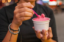 Girl holding a raspberry gelato ice cream cup